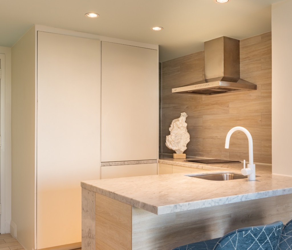 a kitchen with counter space, a kitchen skink and stove