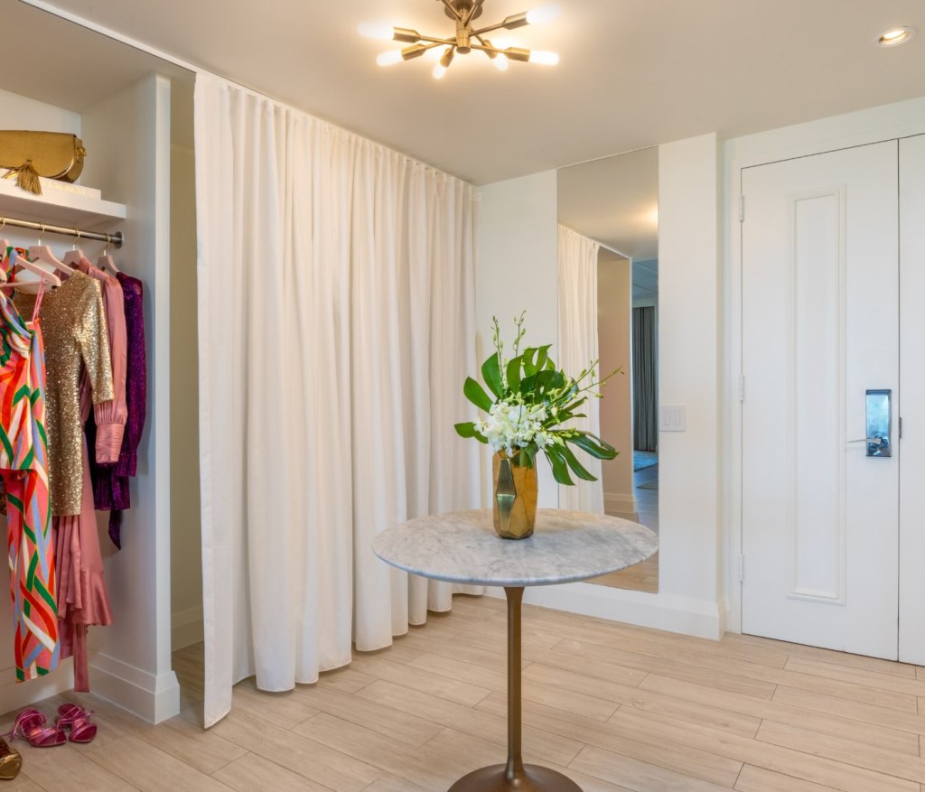 the entryway with closet space and a small table in the middle of the room