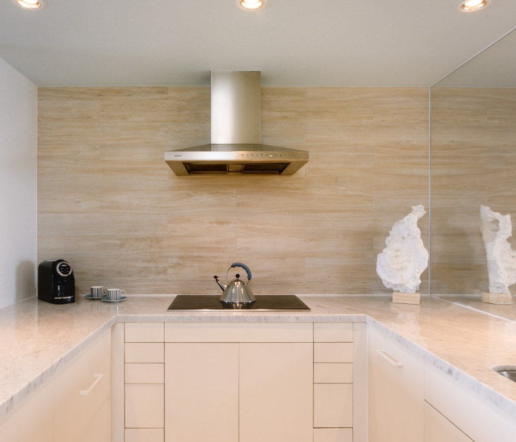 a large kitchen space with a stove that has a kettle on top