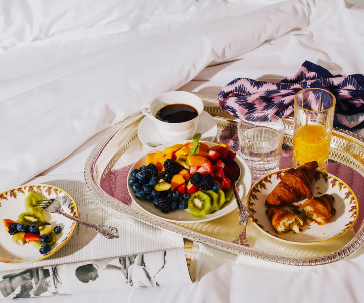 Un somptueux petit déjeuner élégamment disposé sur un lit moelleux. 