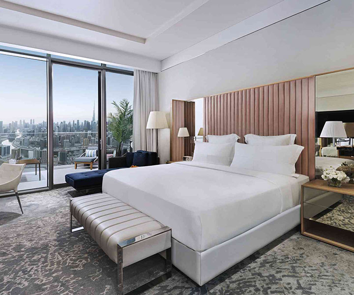 Luxurious hotel room with king-sized bed and stunning city view.