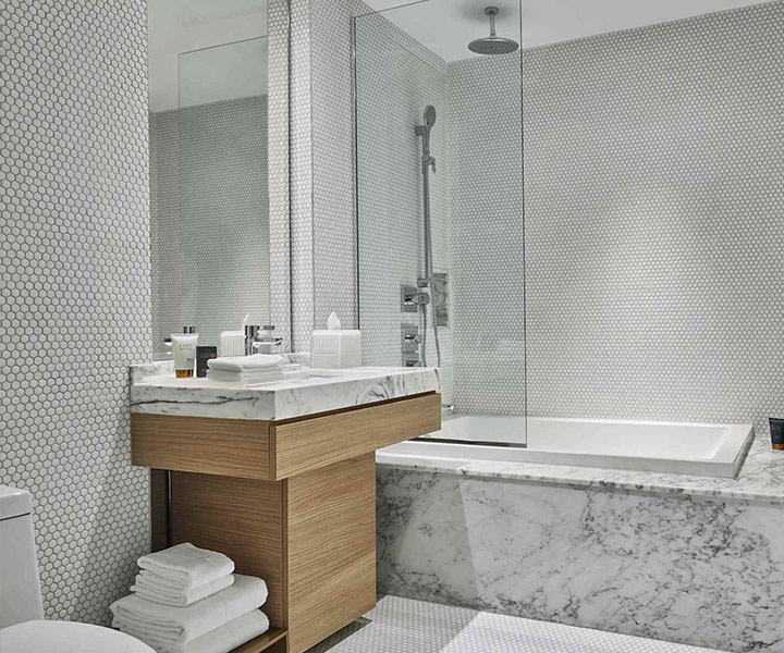 a beautifully designed bathoom with shower and bathtub