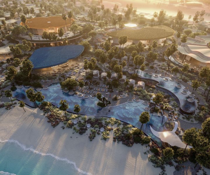 Vue aérienne d’un resort sur la plage avec quelques piscines.