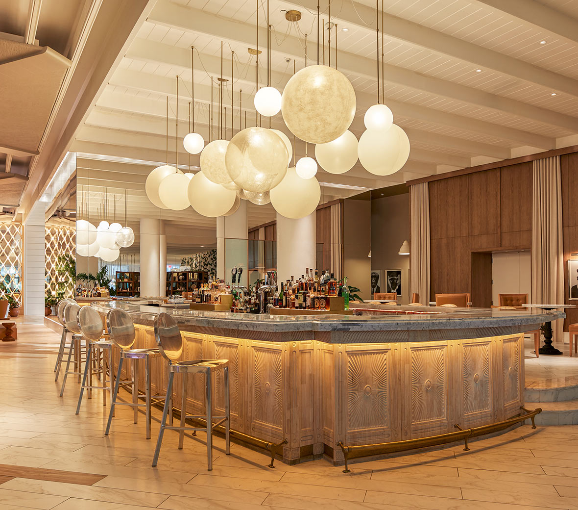 A spacious bar adorned with numerous hanging lights illuminating the area.