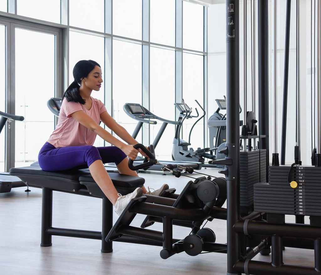 Woman on a weights machine in the gym at SLS Dubai