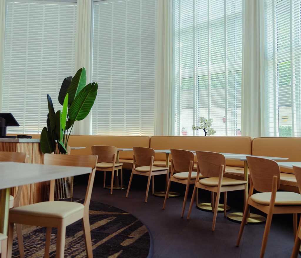 Several tables and chairs in an empty dining room of Katsuya South Beach