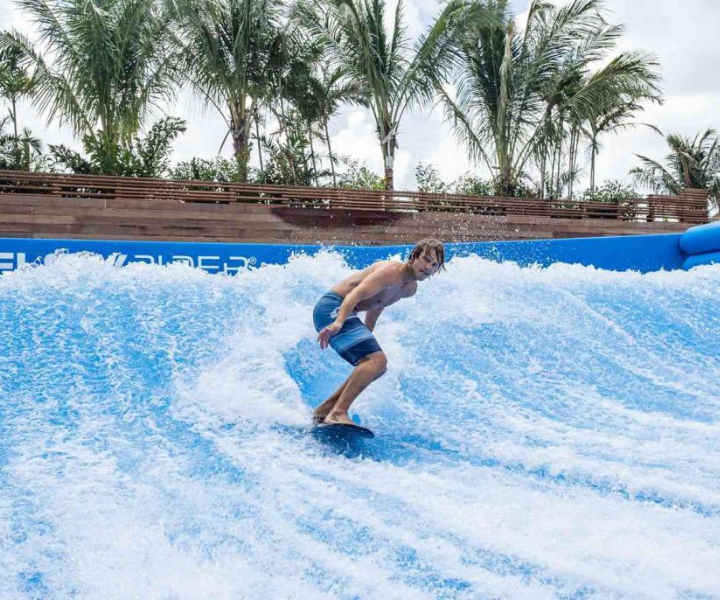 a kid surfing on a state of the art surf simulator