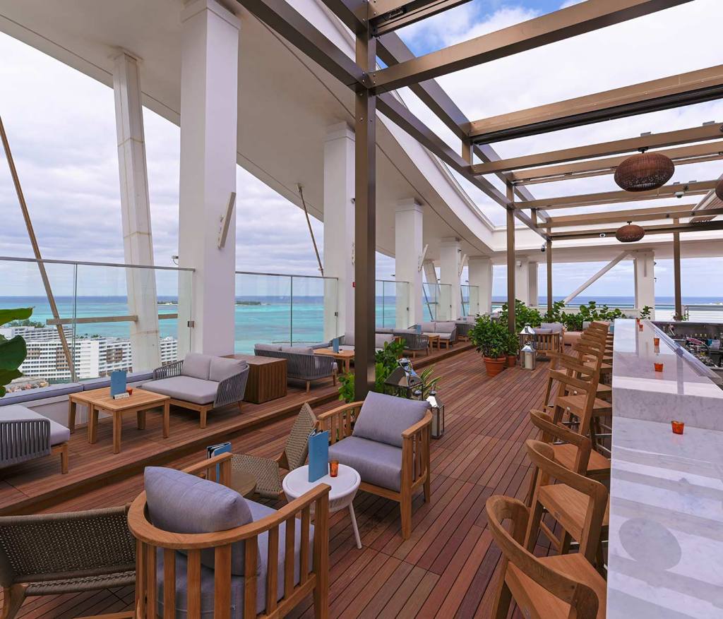 Image of Skybar, rooftop bar at SLS Baha Mar, with ample seating overlooking the ocean.