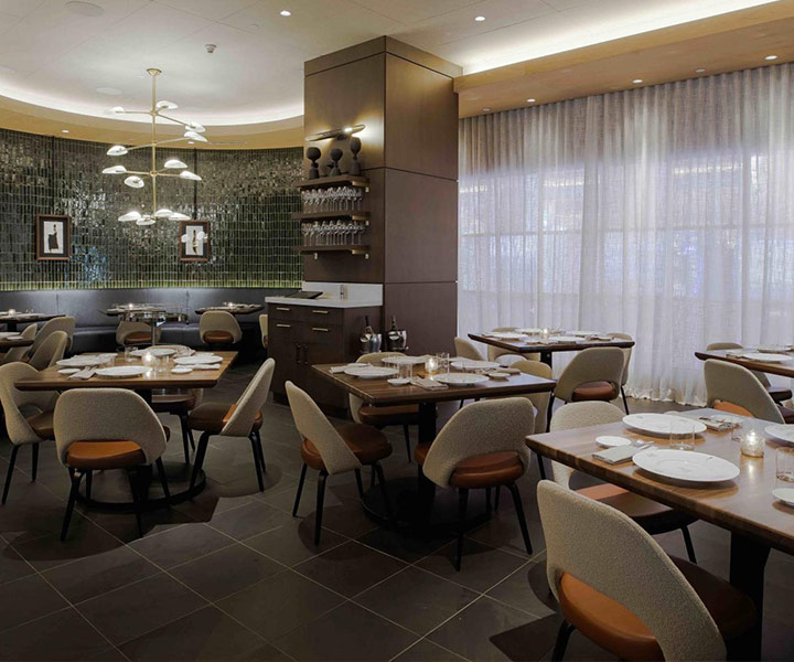 Interior of Carna Baha Mar steakhouse, with modern tables and chairs.