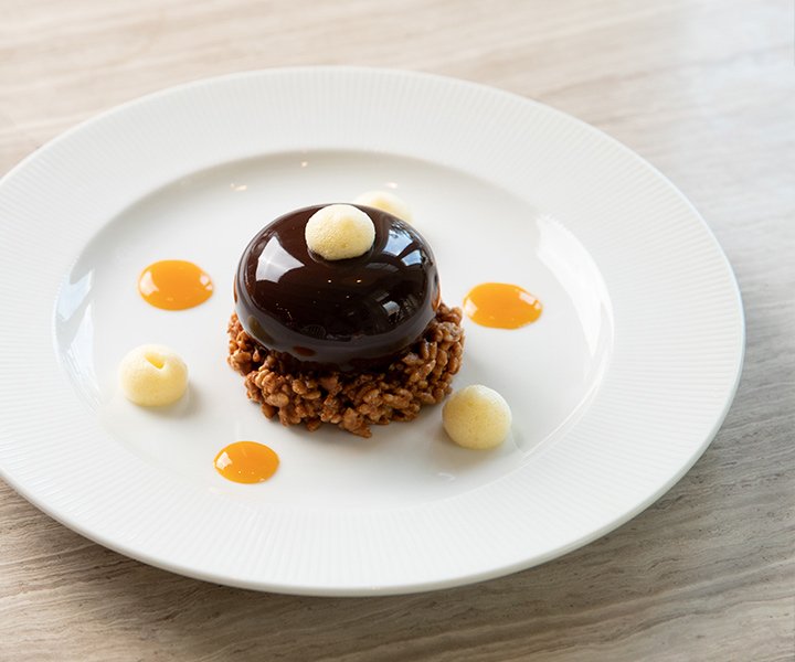 A dessert on a white plate: a delectable treat served elegantly, enticingly presented for indulgence.