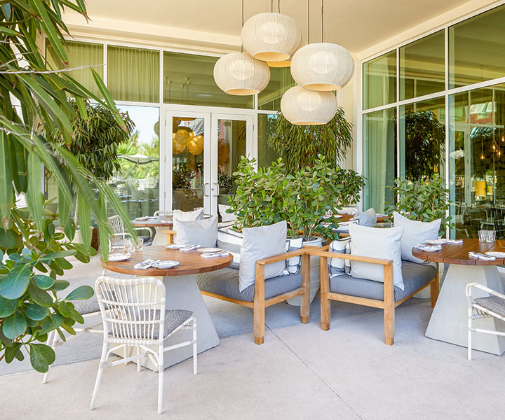 Cleo Baha Mar restaurant patio with white chairs and tables.