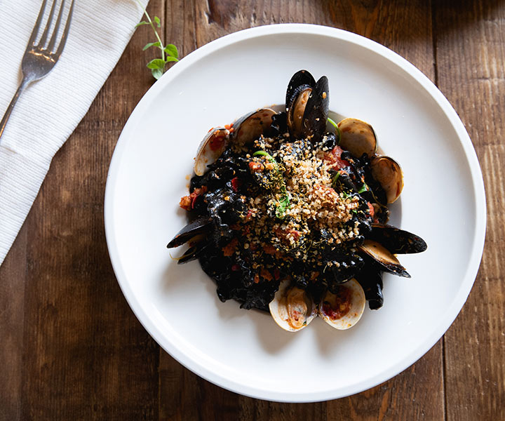 A plate of seafood featuring clams and mussels.