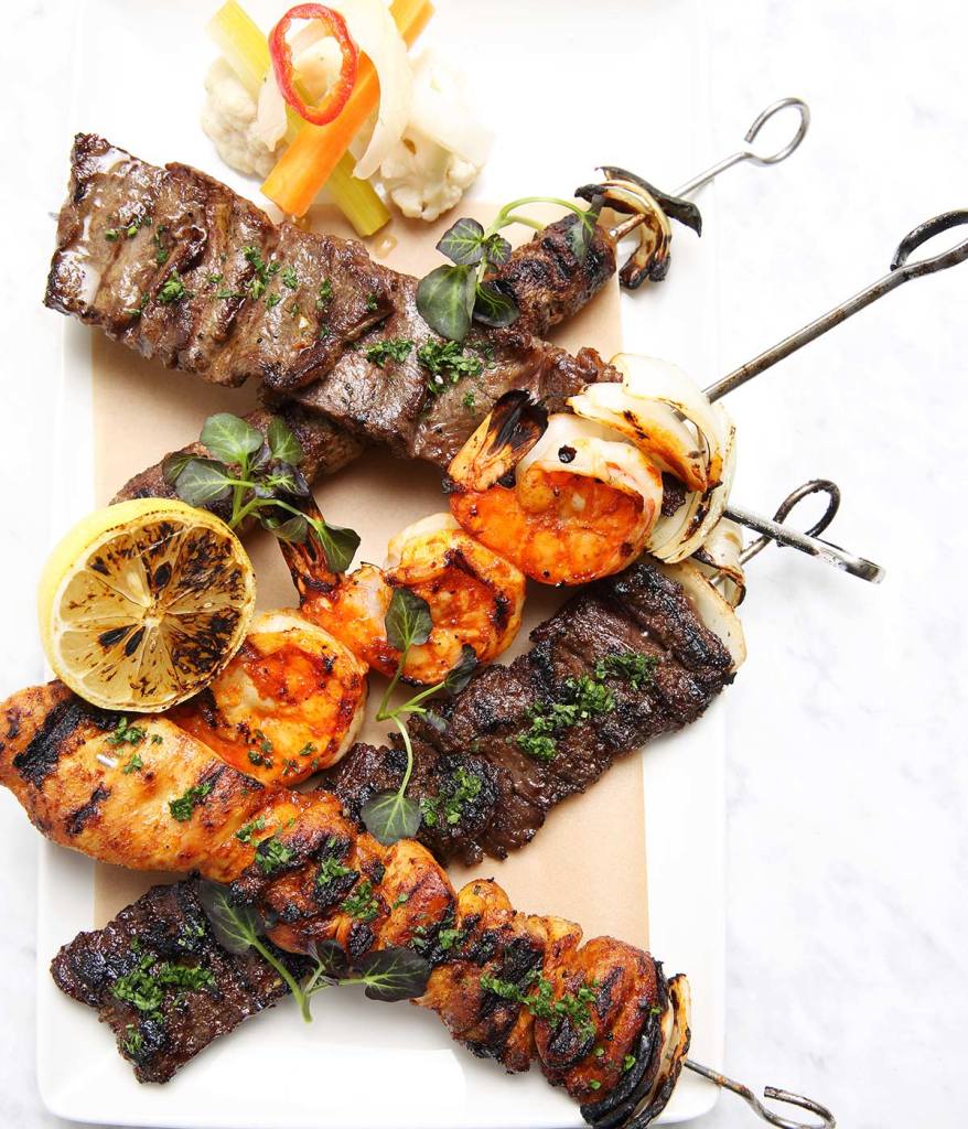 Variety of grilled kebabs captured from overhead