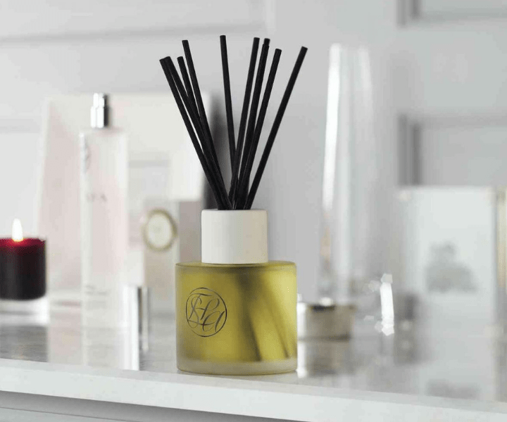 a full scent diffuser on a table with other spa products