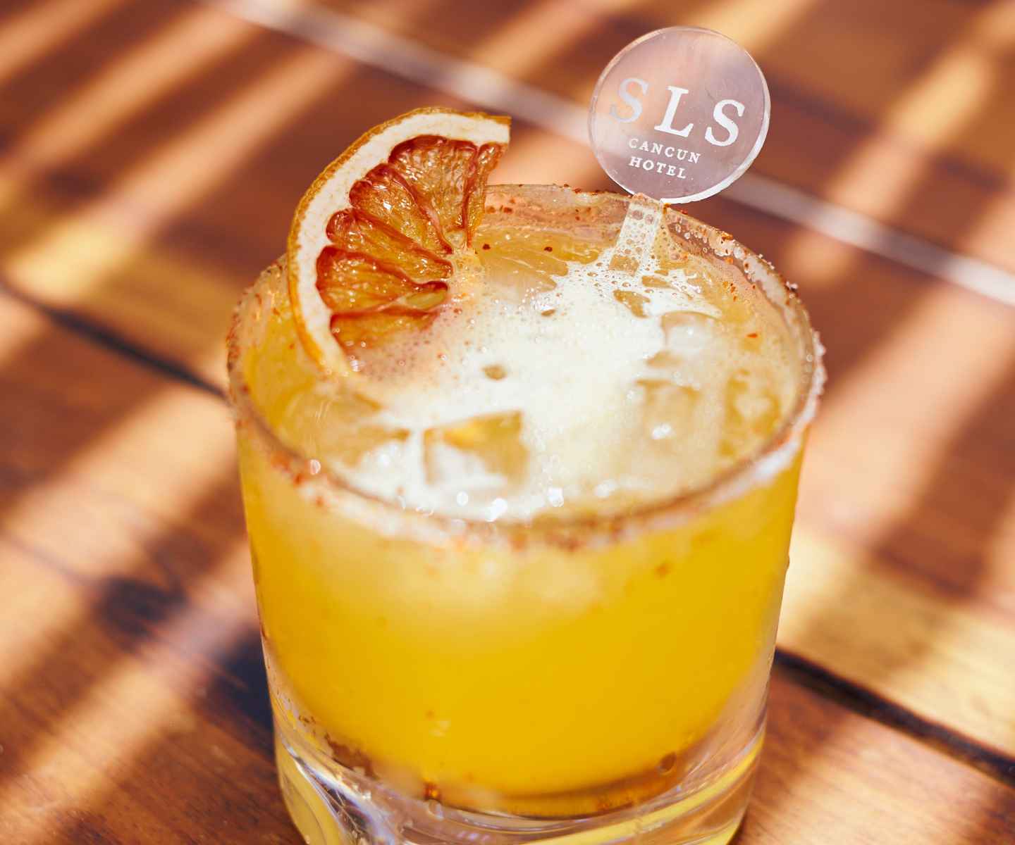 Vibrant orange cocktail with an orange garnish