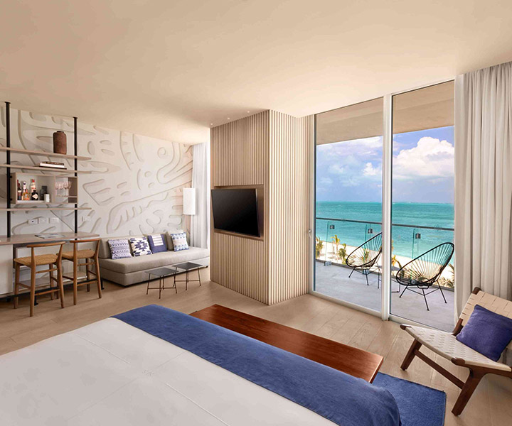 A lavish hotel room overlooking the vast ocean.