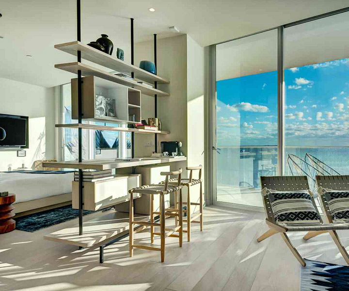 Exquisite hotel room, adorned with contemporary elegance, offers a breathtaking ocean vista.