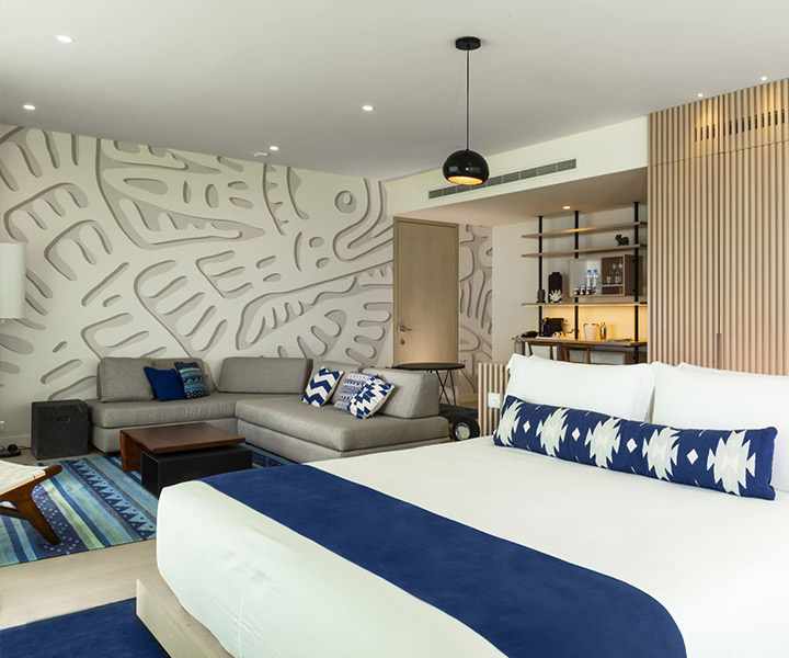 Luxurious modern hotel room with elegant blue and white decor.