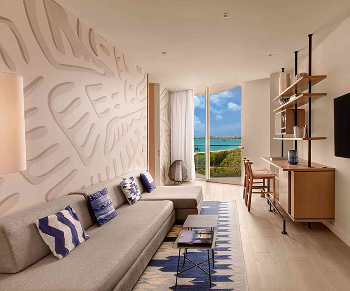 Luxurious modern living room overlooking the ocean, featuring elegant decor and breathtaking views.