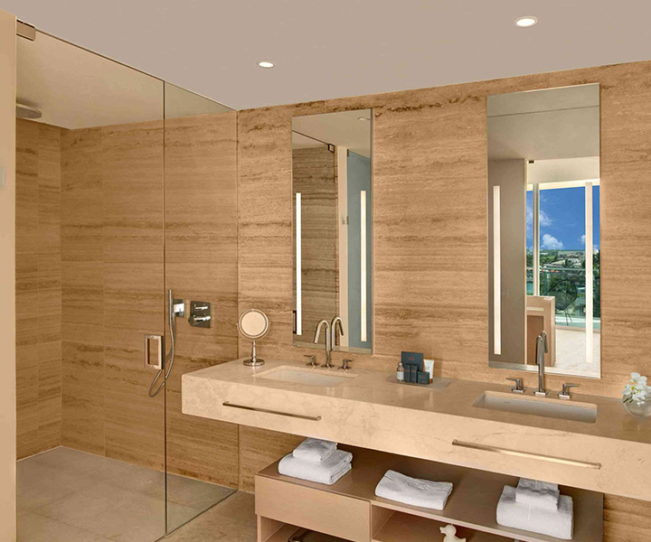 Luxurious bathroom with spacious walk-in shower and elegant double sink.
