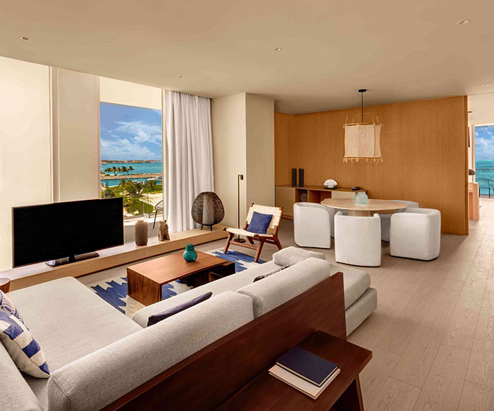 A lavish living room adorned with opulent furnishings, offering a breathtaking vista of the endless ocean beyond.