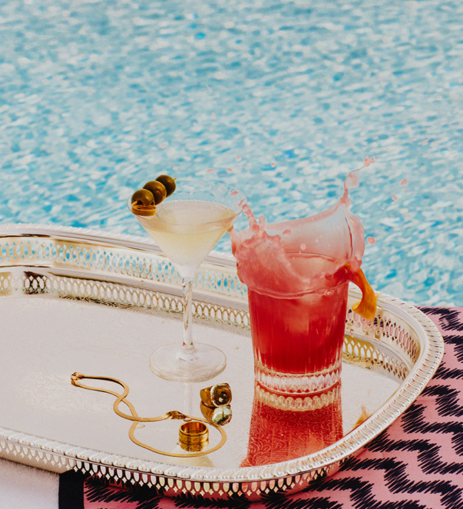 A lavish tray adorned with an assortment of exquisite cocktails and jewelry.