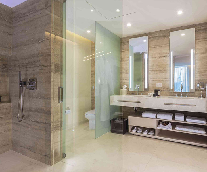 Luxurious bathroom featuring a sleek glass shower door and elegant sink.