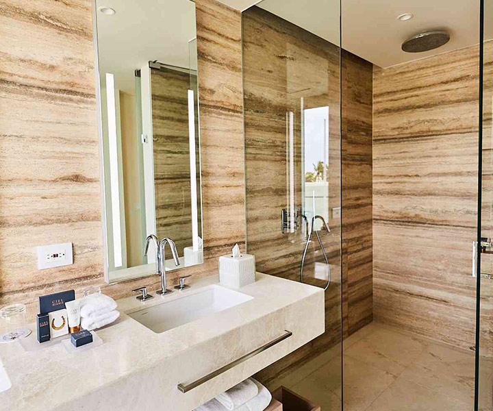 Luxurious bathroom with glass shower door and elegant sink.