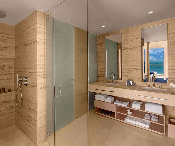 Luxurious bathroom with spacious walk-in shower and oversized mirror.