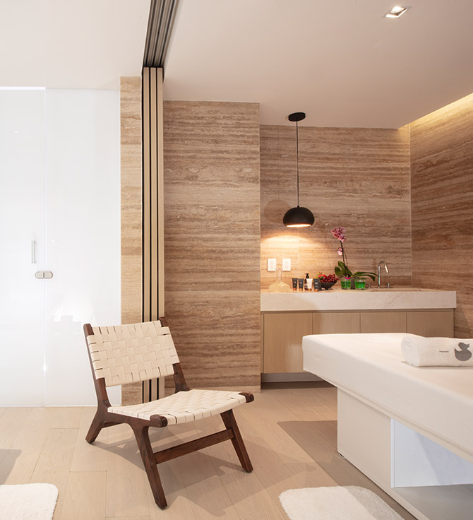 Imagem do Ciel Spa Cancun, com uma cadeira em tecido e uma mesa de massagem branca numa sala de tratamento de spa.