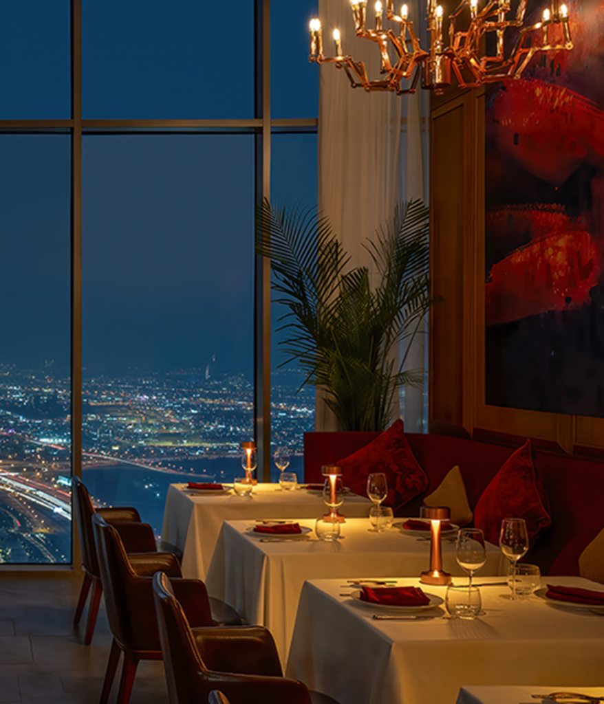 The dinning room of Carna Dubai in the evening with views