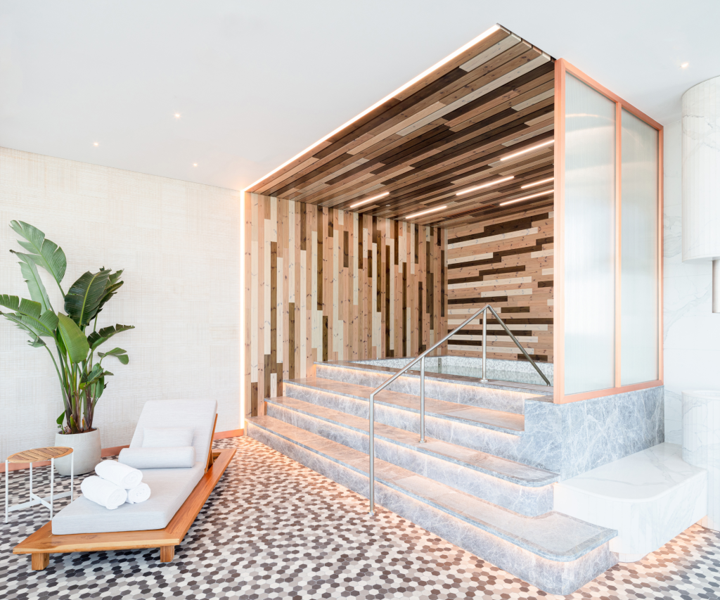 stairs leading to a beautifully designed hot tub area with lounge seating.