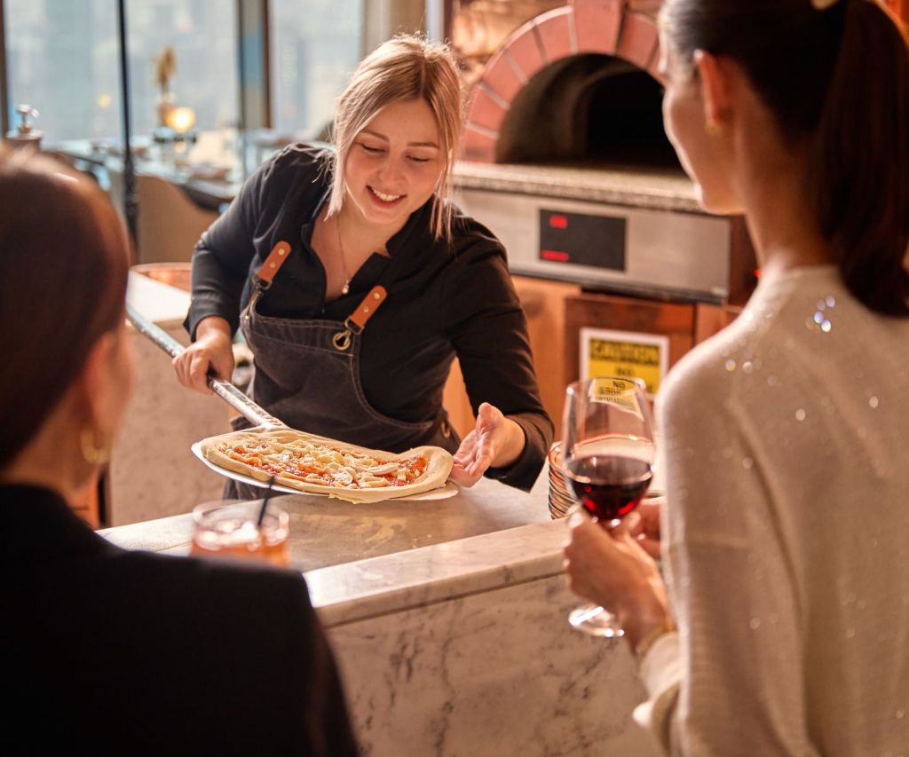 Chef leading a pizza making class with guests of Fi'lia Dubai