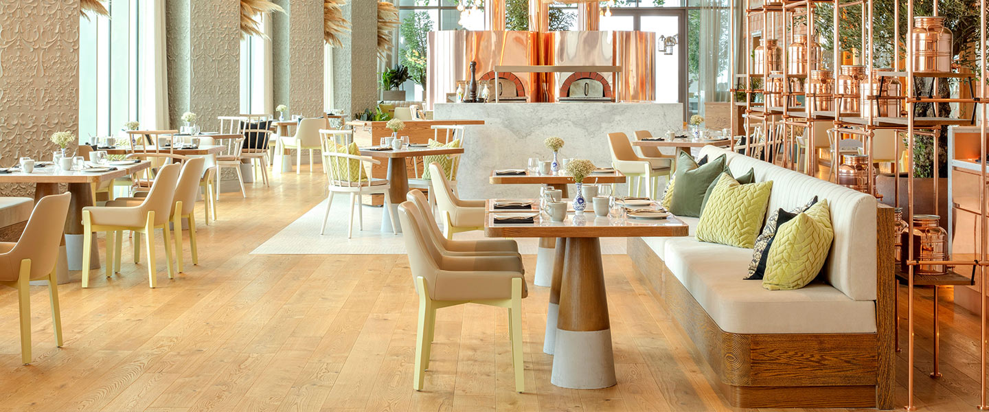 Fi'lia at SLS Dubai, a bright restaurant with modern furnishings.