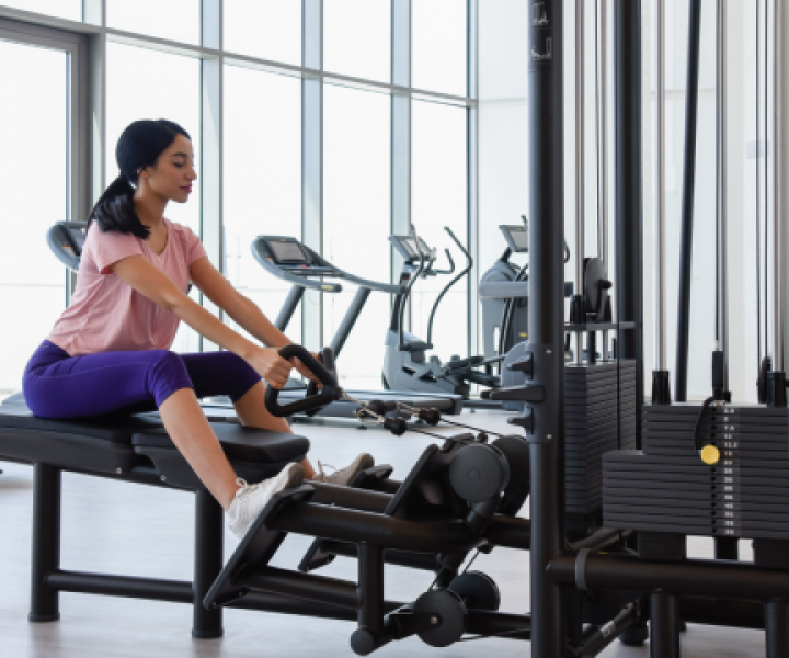 A woman exercising on a rowing machine in sls dubai gym.