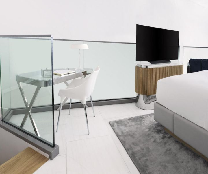 A contemporary bedroom featuring a bed and a glass wall.