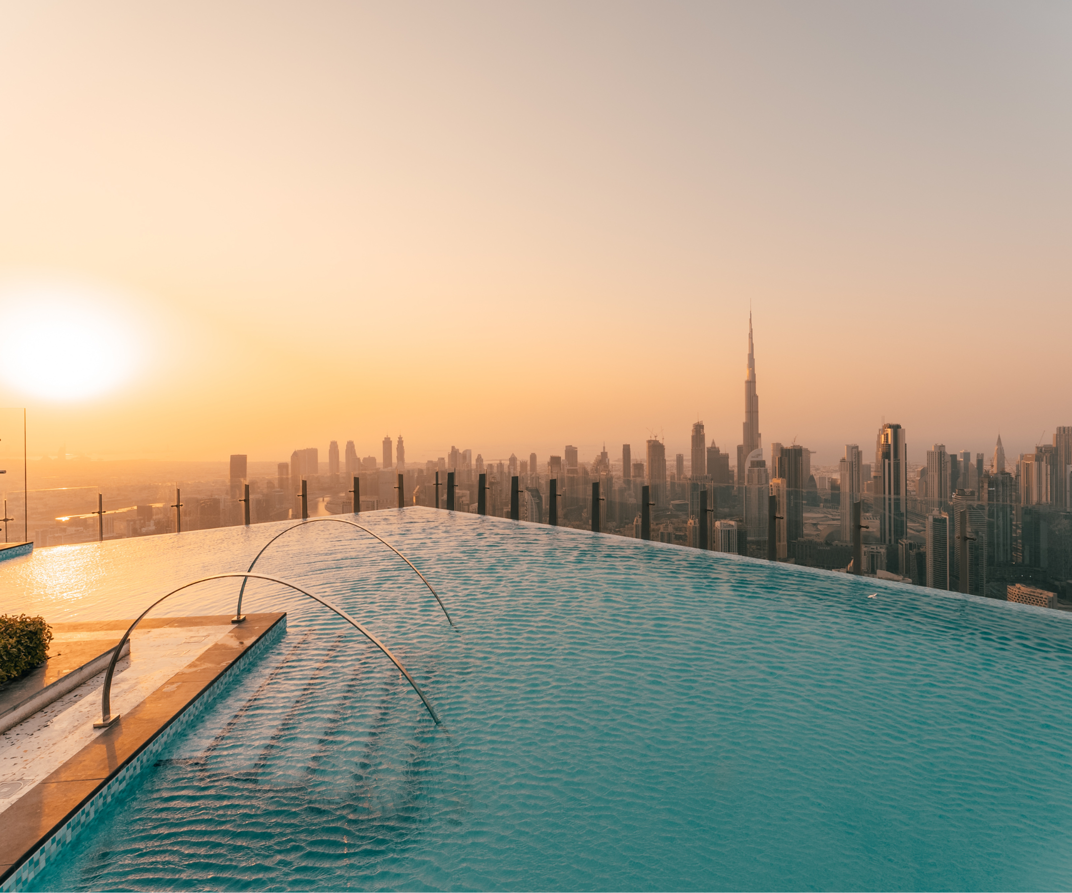 The dazzling rooftop infinity pool at sunset, with fantastical orange skies