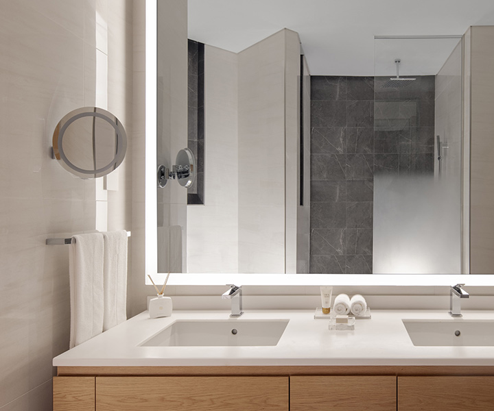 Beautifully designed bathroom with two sinks and and large mirror.