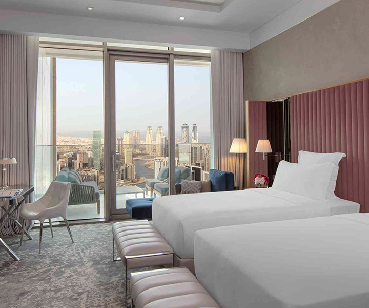 Luxurious hotel room with two beds and stunning city view