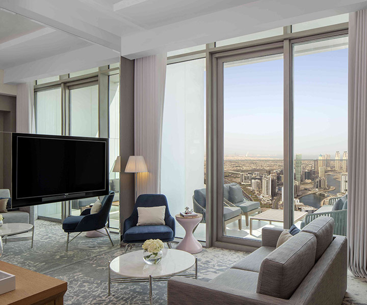 A modern living room with a big TV and city skyline view.