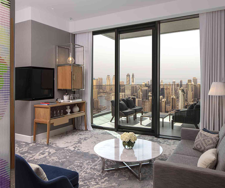 A modern living room with a big TV and city skyline view.