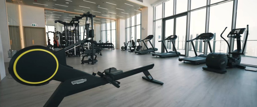 Spacious gym studio with different types of gym equipment