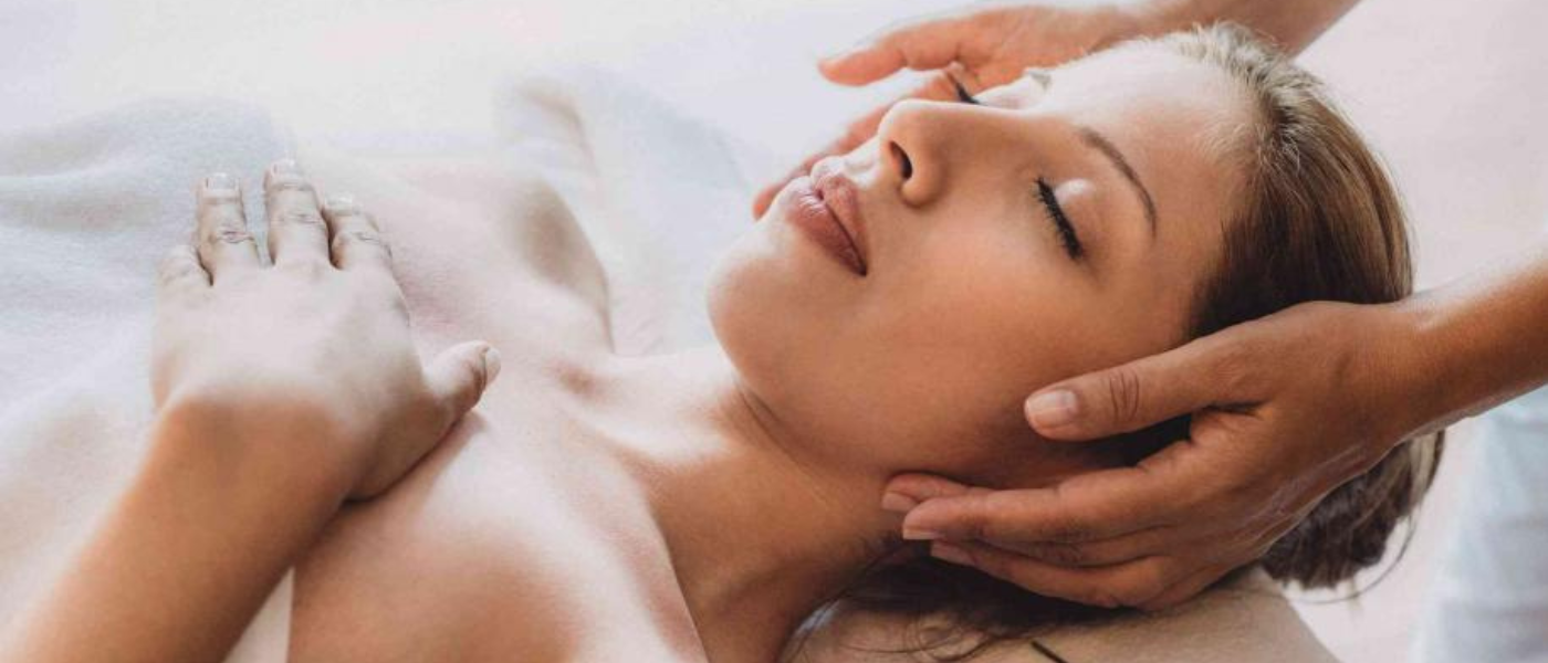 A relaxed woman receiving a facial treatment