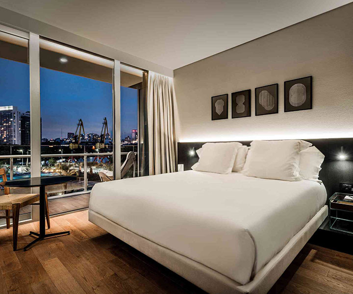 Luxurious bedroom overlooking the city skyline.