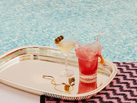 A lavish tray adorned with an assortment of exquisite cocktails and jewelry.