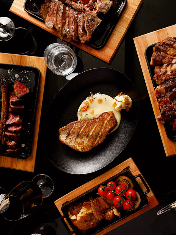A lavish spread of delectable fine steaks and meats, along with scrumptious sides.