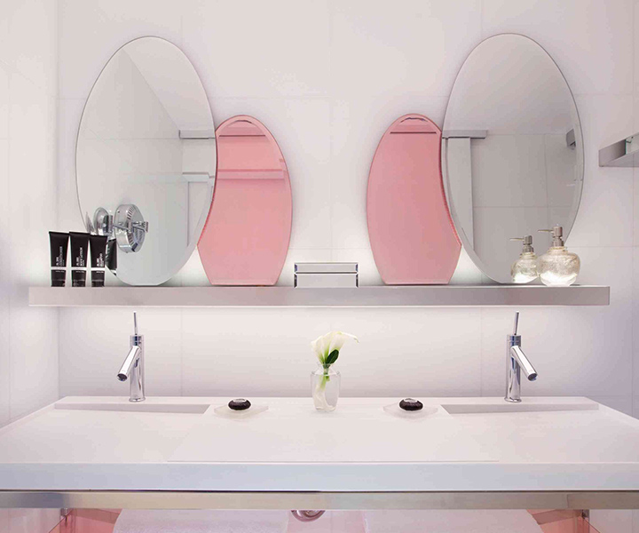 A lavishly adorned bathroom showcasing twin sinks and exquisite mirrors.