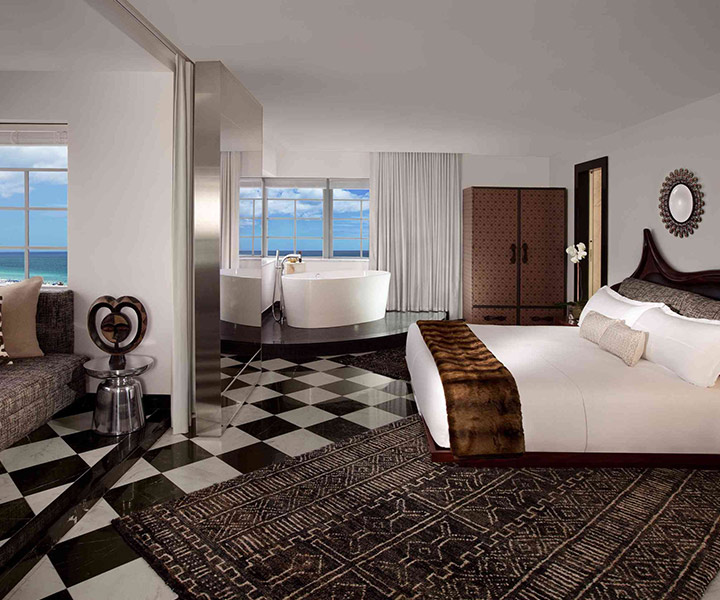 Spacious hotel room with king-sized bed and ocean view.