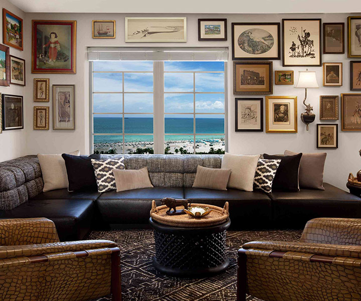 A lavish living room adorned with a plush couch, an elegant coffee table, and a large window offering a scenic view.