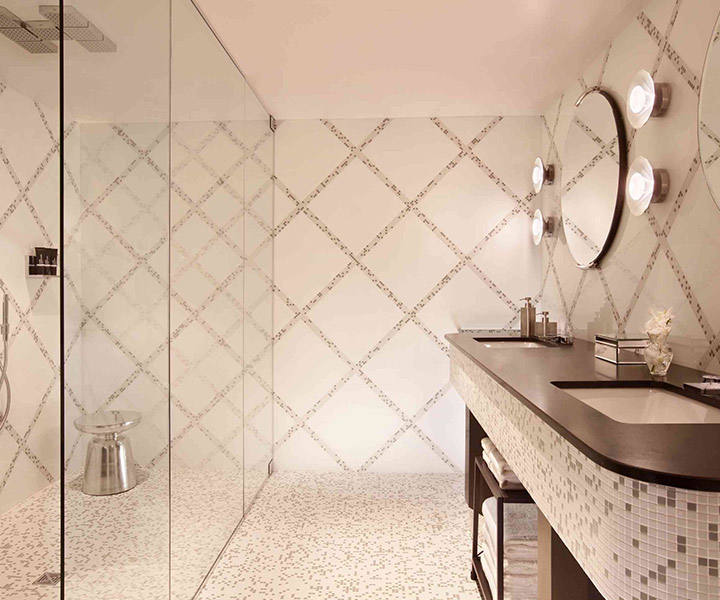 A lavishly adorned bathroom showcasing a sleek shower and an elegant sink.